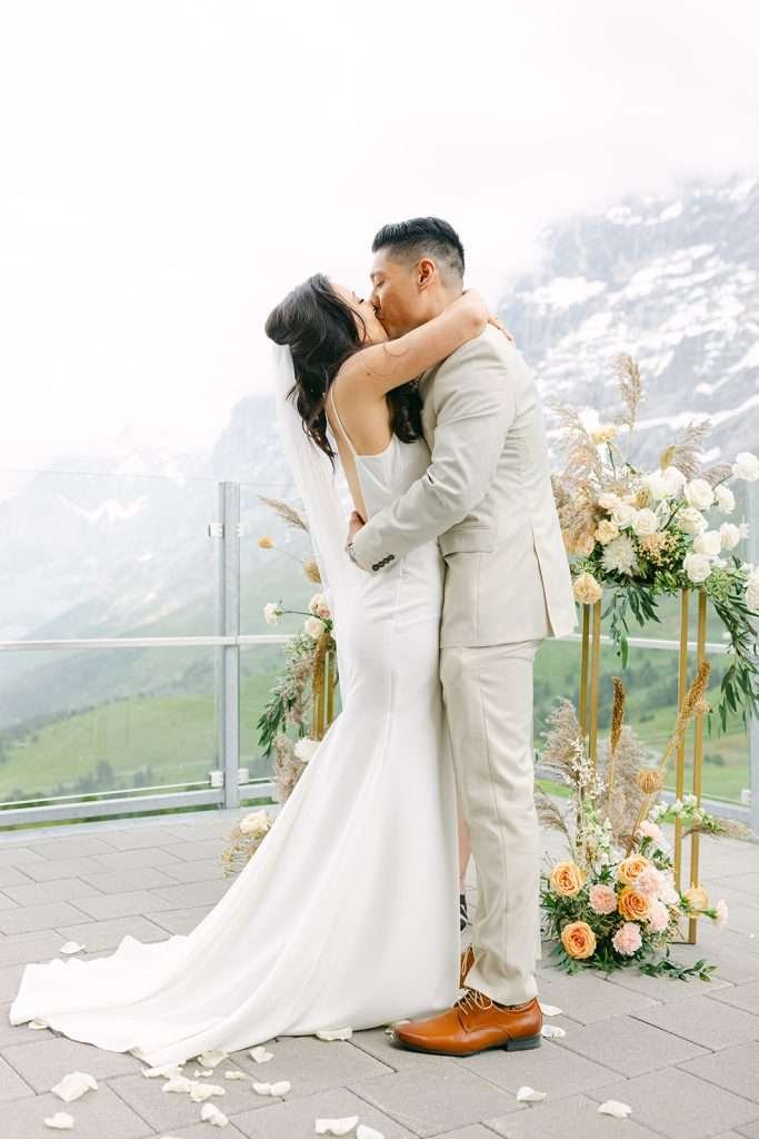 A married couple on their wedding having their first Kiss