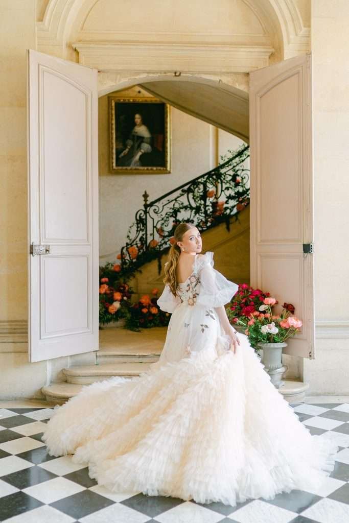 bride twirls in her dress in the foyer of the Chateau de Champlatreux Wedding venue