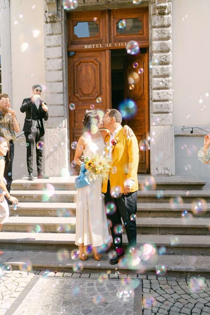 A bride and groom kissing after their civil wedding ceremony.