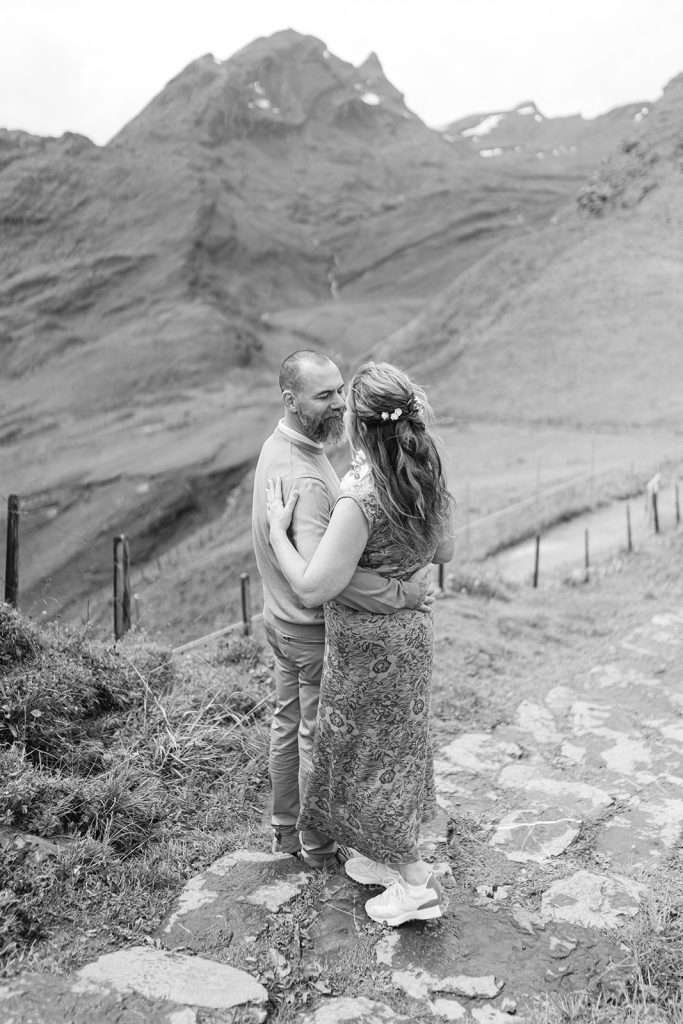 A couple looking at each other in Grindelwald, during their engagement photo session.