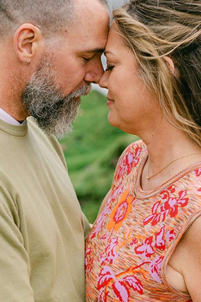 A couple, forhead to forhead, during their engagement shoot in Lauterbrunnen.