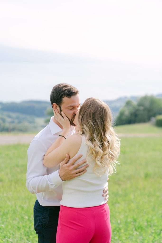 A couple kissing during their engagement shoot in Lavaux Switzerland.