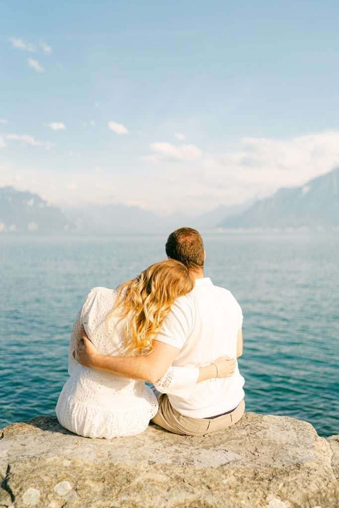 A couple holding each other by the Lake Geneva, In Lavaux Switzerland