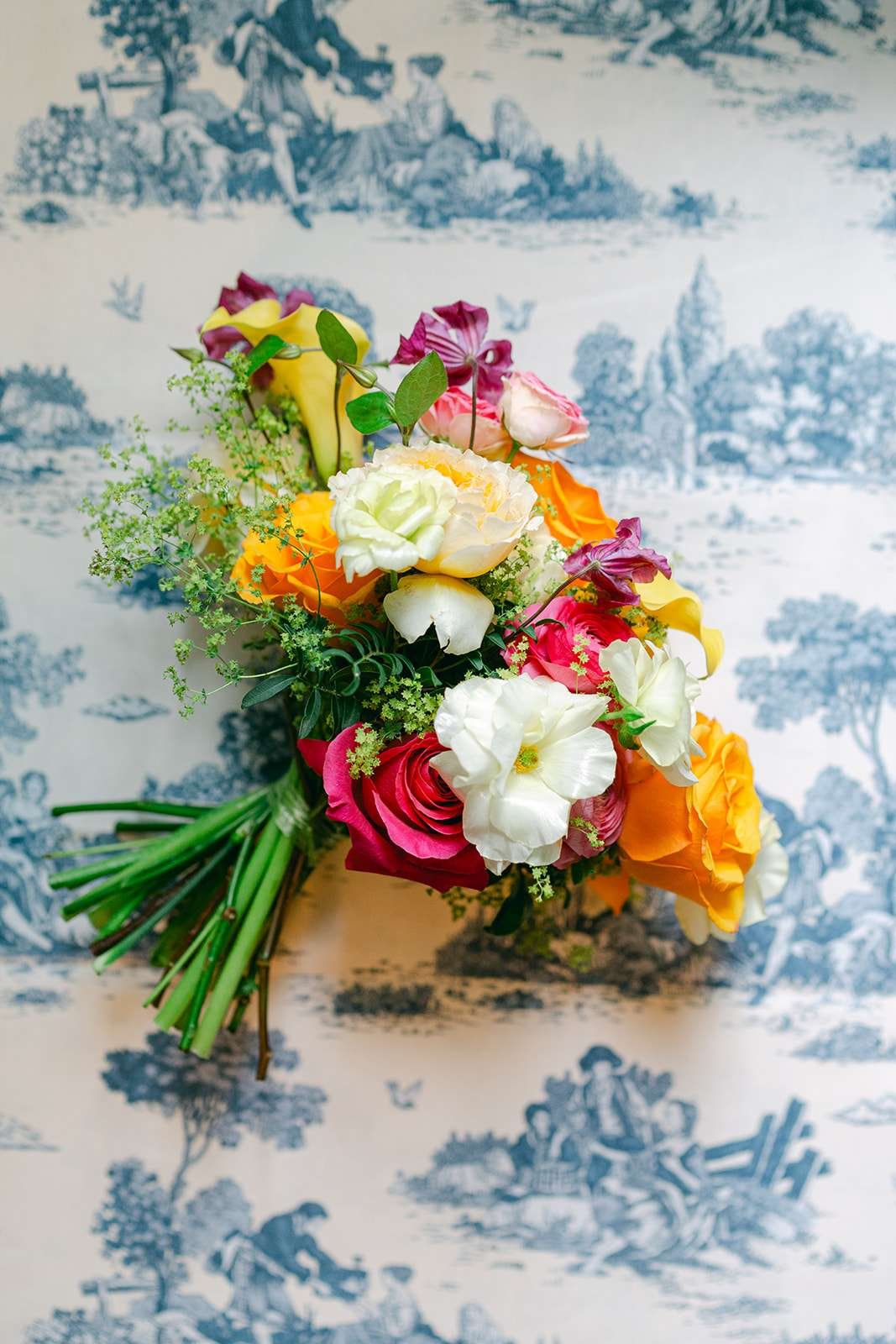 Details of a vibrant colorful bouquet on a blue print tablecloth