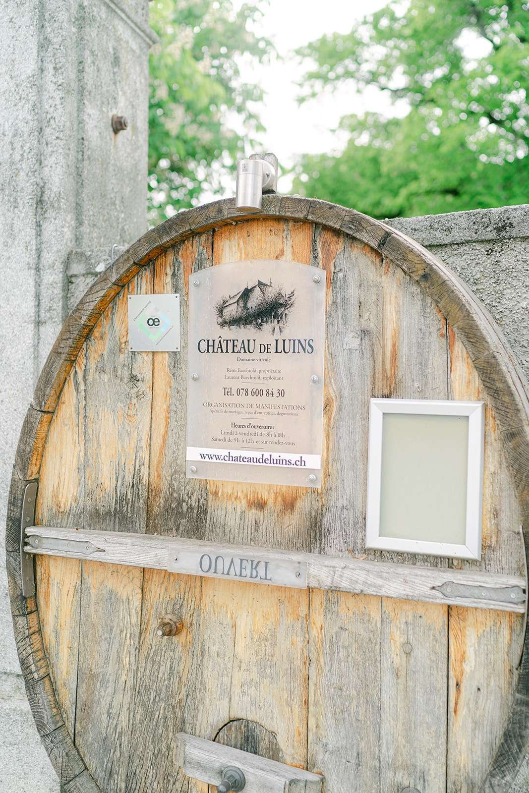 Details of a Château de Luins wedding venue sign on a barrel top