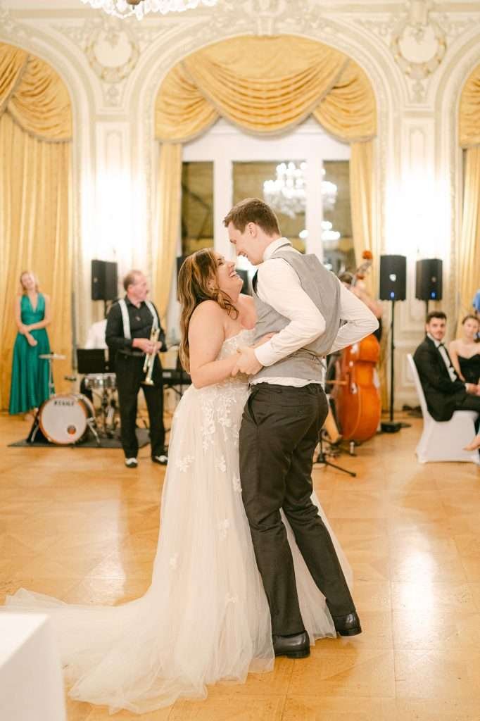Newlyweds giggle during their first dance with a live band at their Grand Hotel Suisse Majestic wedding