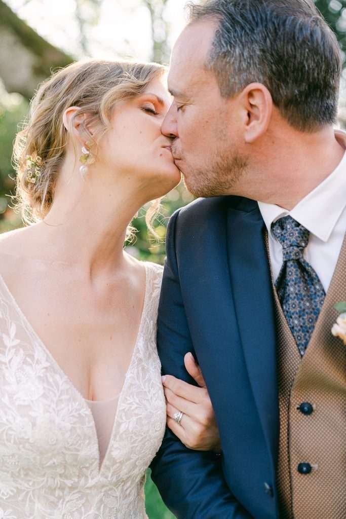 Newlyweds kiss at sunset