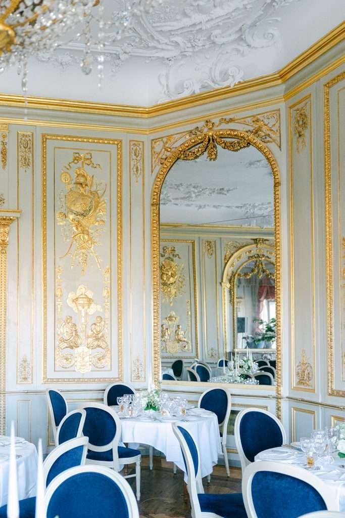 A peak at the stunning Hotel du Peyrou wedding reception space with gold trim and a large mirror